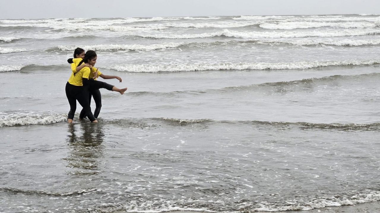 two girls playing in the ocean